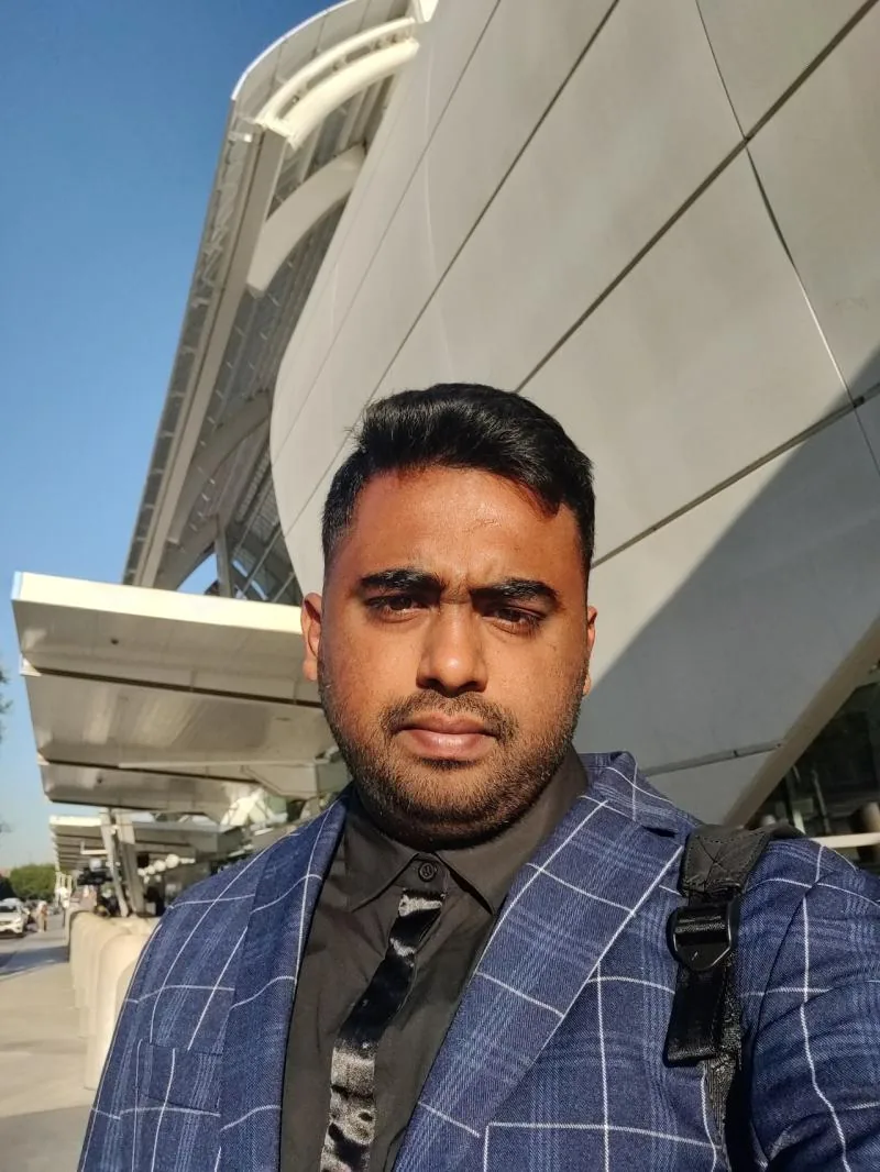 Selfie in plaid blazer outside a modern building