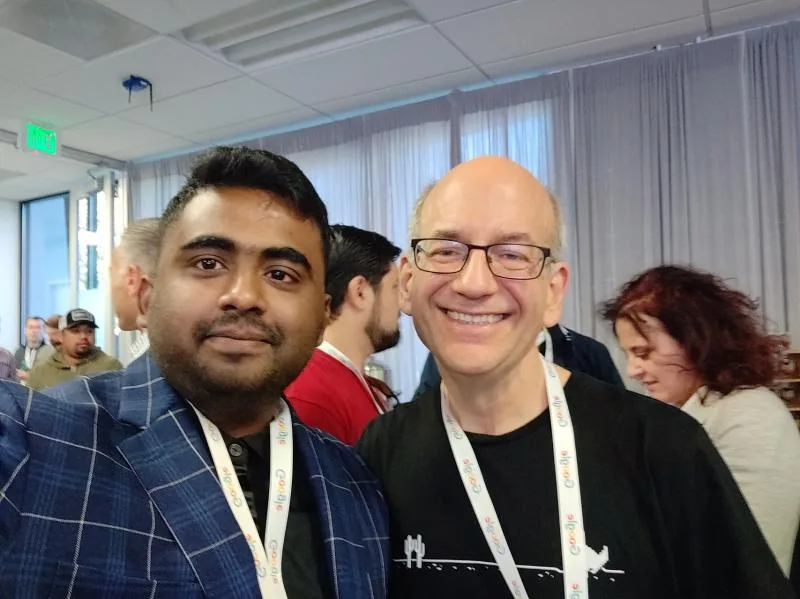 Selfie with a bald attendee in glasses at a conference venue