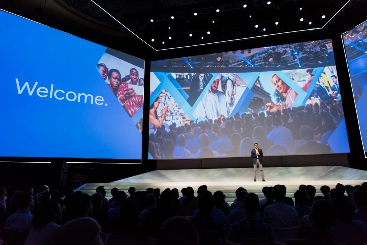 Keynote stage with large "Welcome" screens and audience