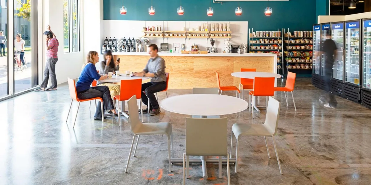 Bright office cafeteria interior with tables and chairs