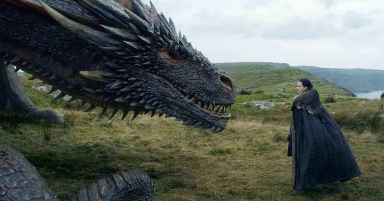 TV-style still of a dragon facing a cloaked figure on a cliff