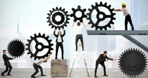 Illustration of businesspeople moving large interlocking gears