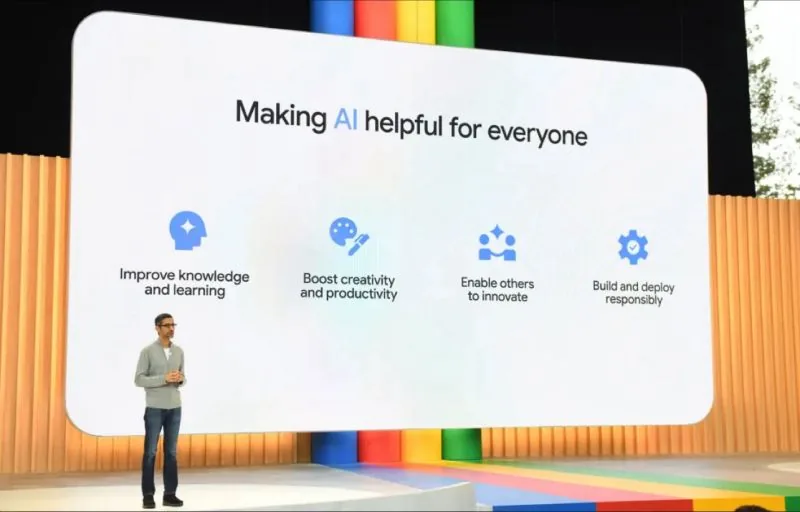 Google keynote frame: "Making AI helpful for everyone" with presenter