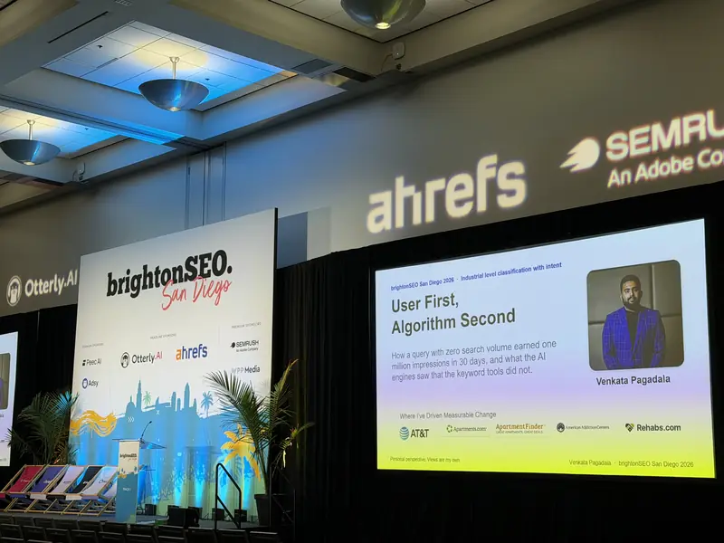 The Track 1 room at brightonSEO San Diego 2026 before the talk, with the title slide, User First, Algorithm Second, on the screen