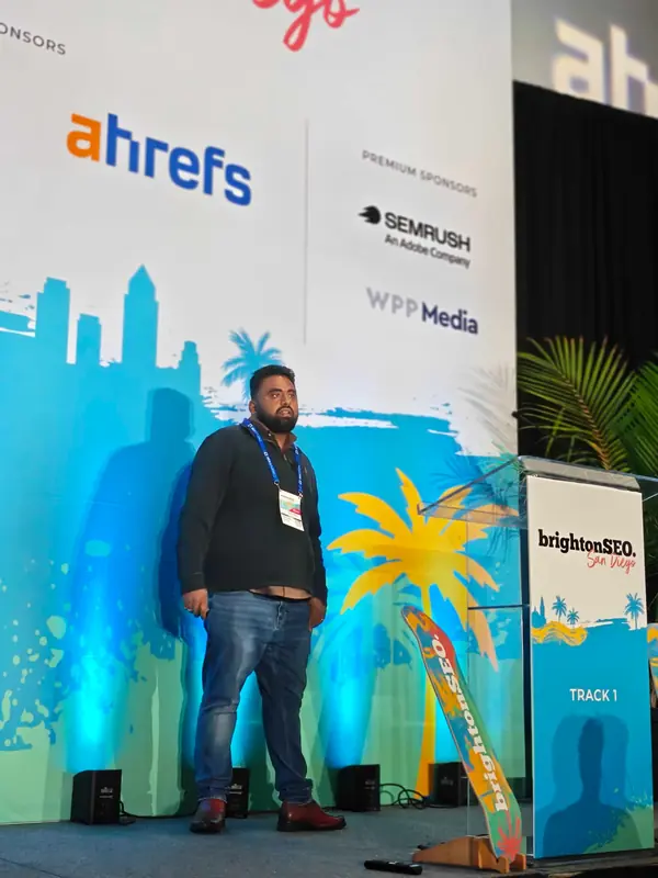 Venkata Pagadala speaking on stage beside the Track 1 lectern at brightonSEO San Diego 2026